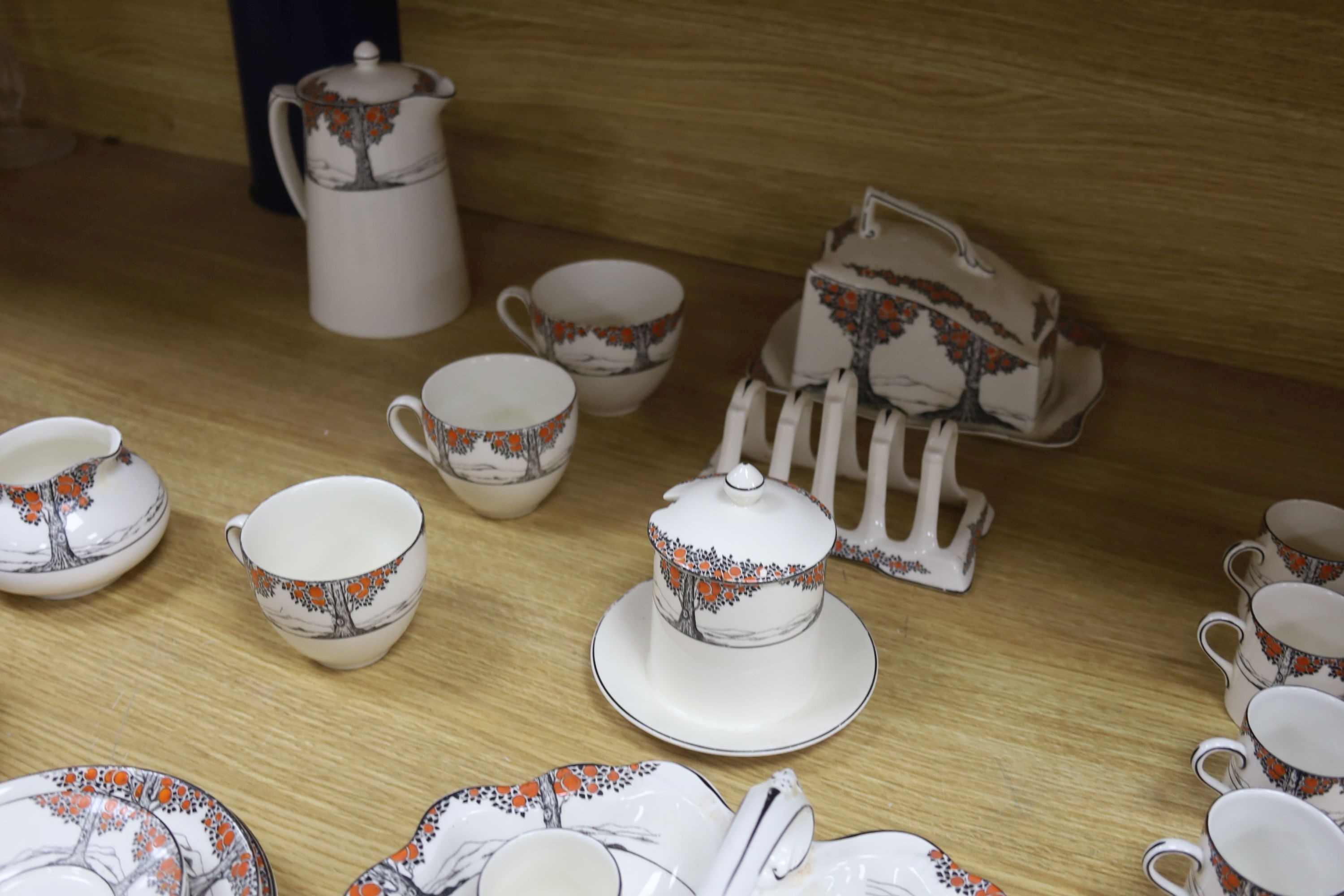 A Crown Ducal Art Deco 'Orange Tree' breakfast, tea and coffee service, to include a biscuit barrel, cheese dish and toast rack